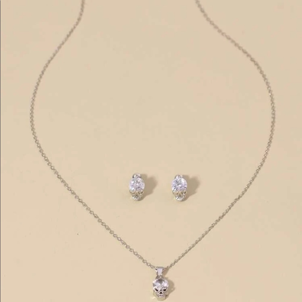 Silver skull necklace & rhinestone earrings